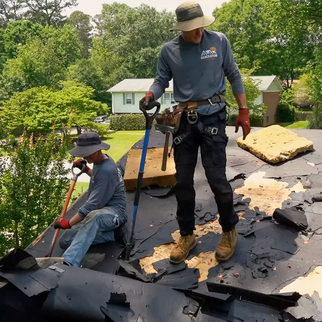 Expert roofers from Generation Roofing, serving Upstate South Carolina, replacing underlayment for superior weather protection.